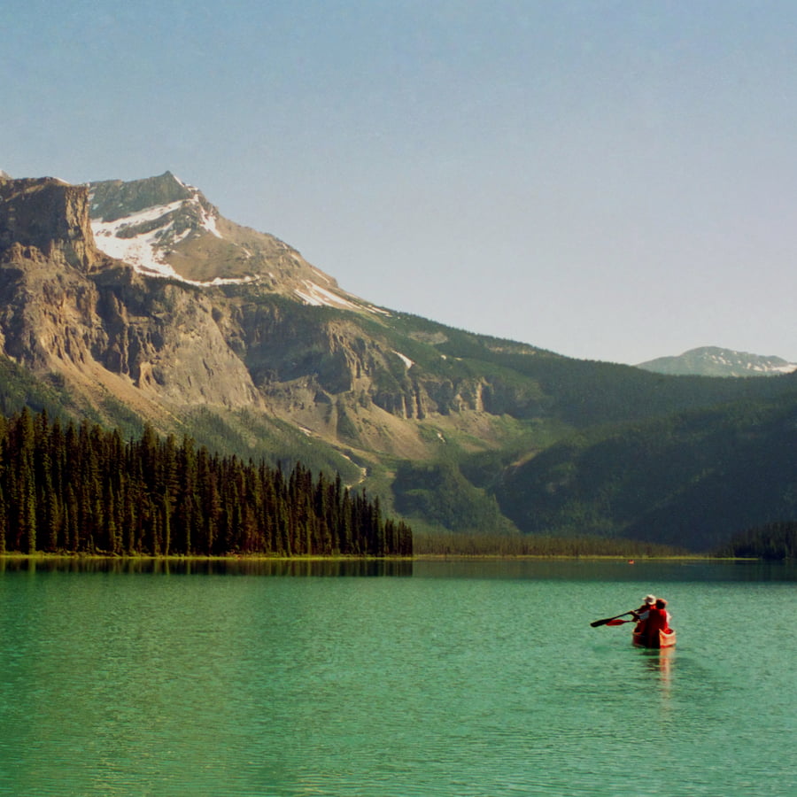 Turistas em um caiaque, praticando canoagem no rio